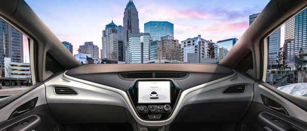 Inside of an autonomous car with view of Charlotte skyline through windshield